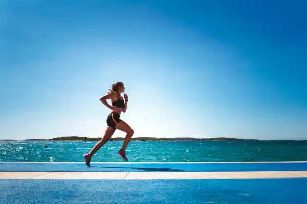 Woman running showing strong leg muscle Feltham